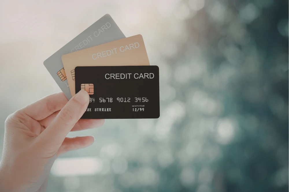 Hand holding three credit cards