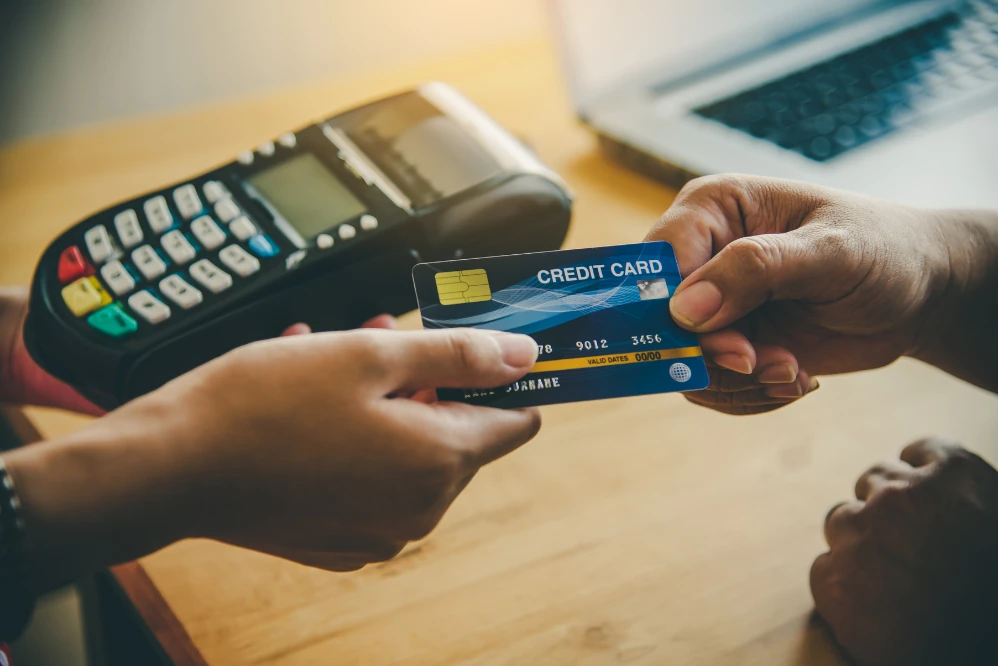 Customer paying with a credit card at a card reader terminal