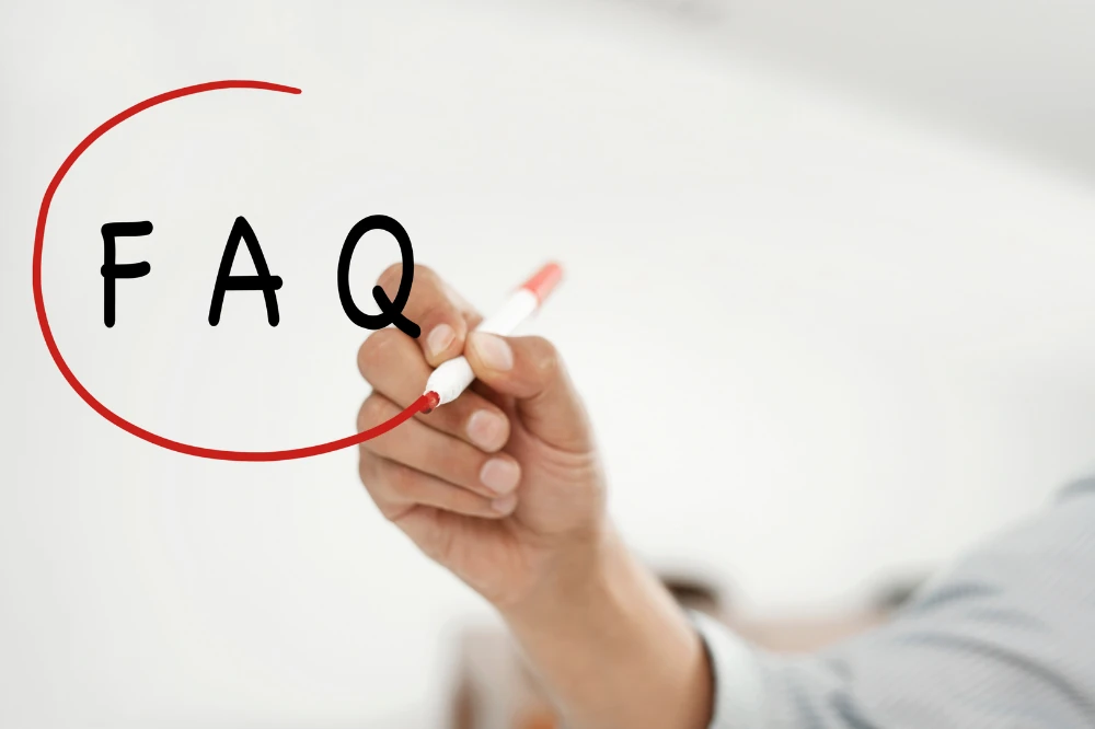 Hand writing FAQ with a red marker